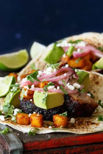 Pork Belly Tacos with Ancho Chili Roasted Pineapple, Avocado, and Pickled Onions | sharedappetite.com