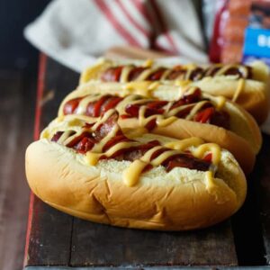 Bacon Wrapped Brats with Cheddar-Beer Sauce and Sriracha | sharedappetite.com