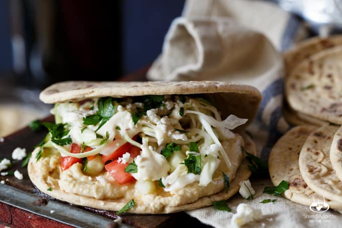 Healthy Mini Vegetarian Greek Sliders with Hummus, Israeli Salad, Pickled Cabbage, and Tahini Sauce | sharedappetite.com