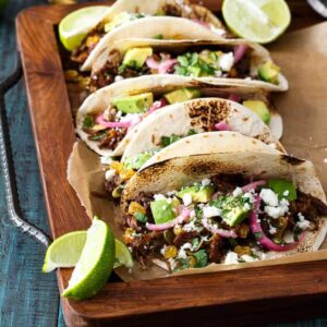 Mexican Lamb Tacos with Tequila Soaked Golden Raisins, Pepitas, and PIckled Onions | sharedappetite.com