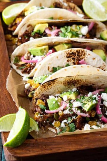 Mexican Lamb Tacos with Tequila Soaked Golden Raisins, Pepitas, and PIckled Onions | sharedappetite.com