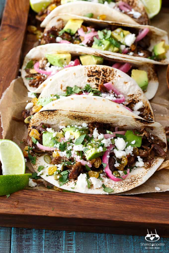 Mexican Lamb Tacos with Tequila Soaked Golden Raisins, Pepitas, and PIckled Onions | sharedappetite.com