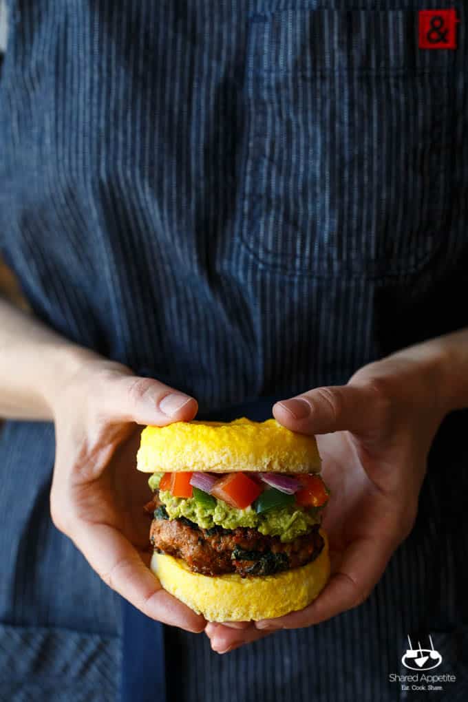 Paleo Southwest Sausage Egg Sandwiches. A healthy Mexican breakfast, using scrambled eggs in place of the bun! Topped with guacamole and pico de gallo, too! 