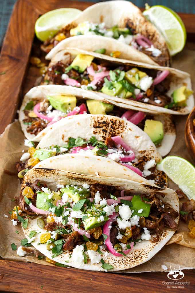 Mexican Lamb Tacos with Tequila Soaked Golden Raisins, Pepitas, and PIckled Onions | sharedappetite.com