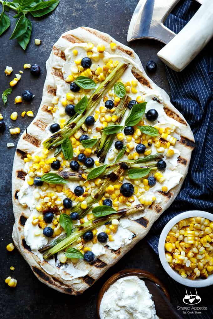 Summer Corn and Blueberry Grilled Pizza with Whipped Goat Cheese and Grilled Scallions. Super quick and easy, perfect for summer easy entertaining! | sharedappetite.com