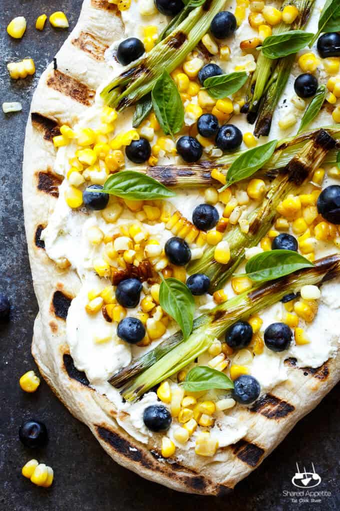 Summer Corn and Blueberry Grilled Pizza with Whipped Goat Cheese and Grilled Scallions. Super quick and easy, perfect for summer easy entertaining! | sharedappetite.com