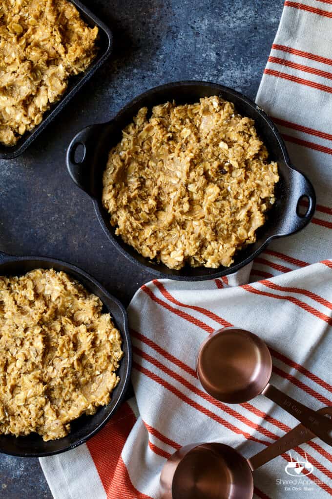 Caramel Apple Crisp Pizookies... a giant skillet oatmeal cookie topped with brown sugar baked apples, caramel sauce, and vanilla ice cream! | sharedappetite.com