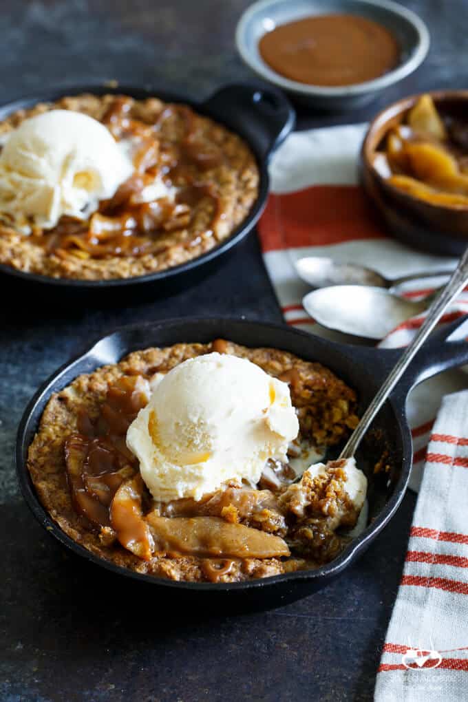 Caramel Apple Crisp Pizookies... a giant skillet oatmeal cookie topped with brown sugar baked apples, caramel sauce, and vanilla ice cream! | sharedappetite.com