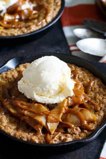 Caramel Apple Crisp Pizookies... a giant skillet oatmeal cookie topped with brown sugar baked apples, caramel sauce, and vanilla ice cream! | sharedappetite.com