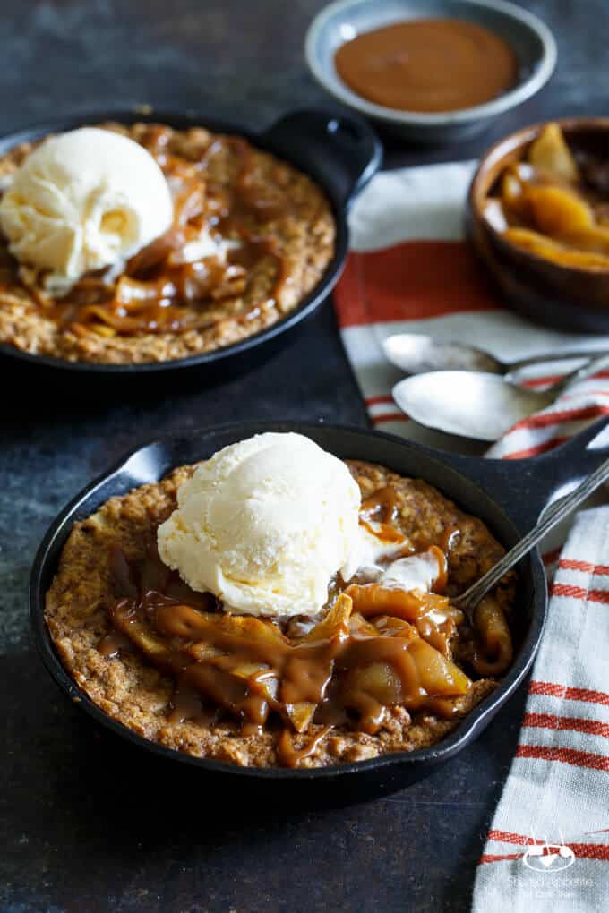 Caramel Apple Crisp Pizookies... a giant skillet oatmeal cookie topped with brown sugar baked apples, caramel sauce, and vanilla ice cream! | sharedappetite.com