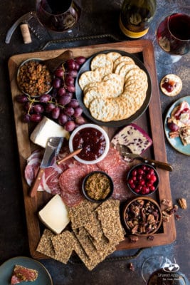 Delicious winter charcuterie board filled with meats, cheeses, and seasonal fruits for entertaining