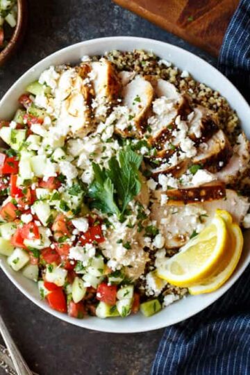 Mediterranean Chicken Quinoa Bowls with Israeli Salad, Hummus, and Tahini Sauce | sharedappetite.com