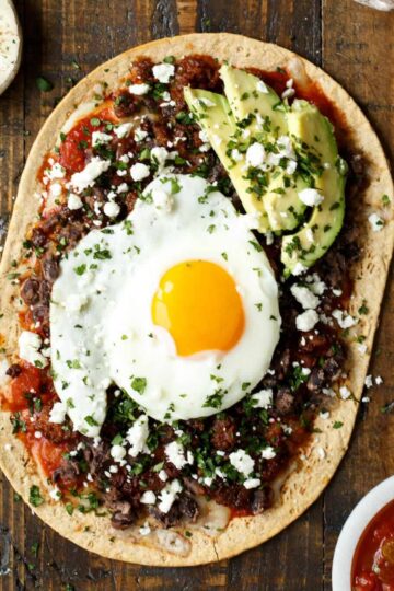 Huevos Rancheros Flatbread Pizza with Monterey Jack Cheese, Salsa, Black Beans, Avocado, and a Fried Egg! sharedappetite.com