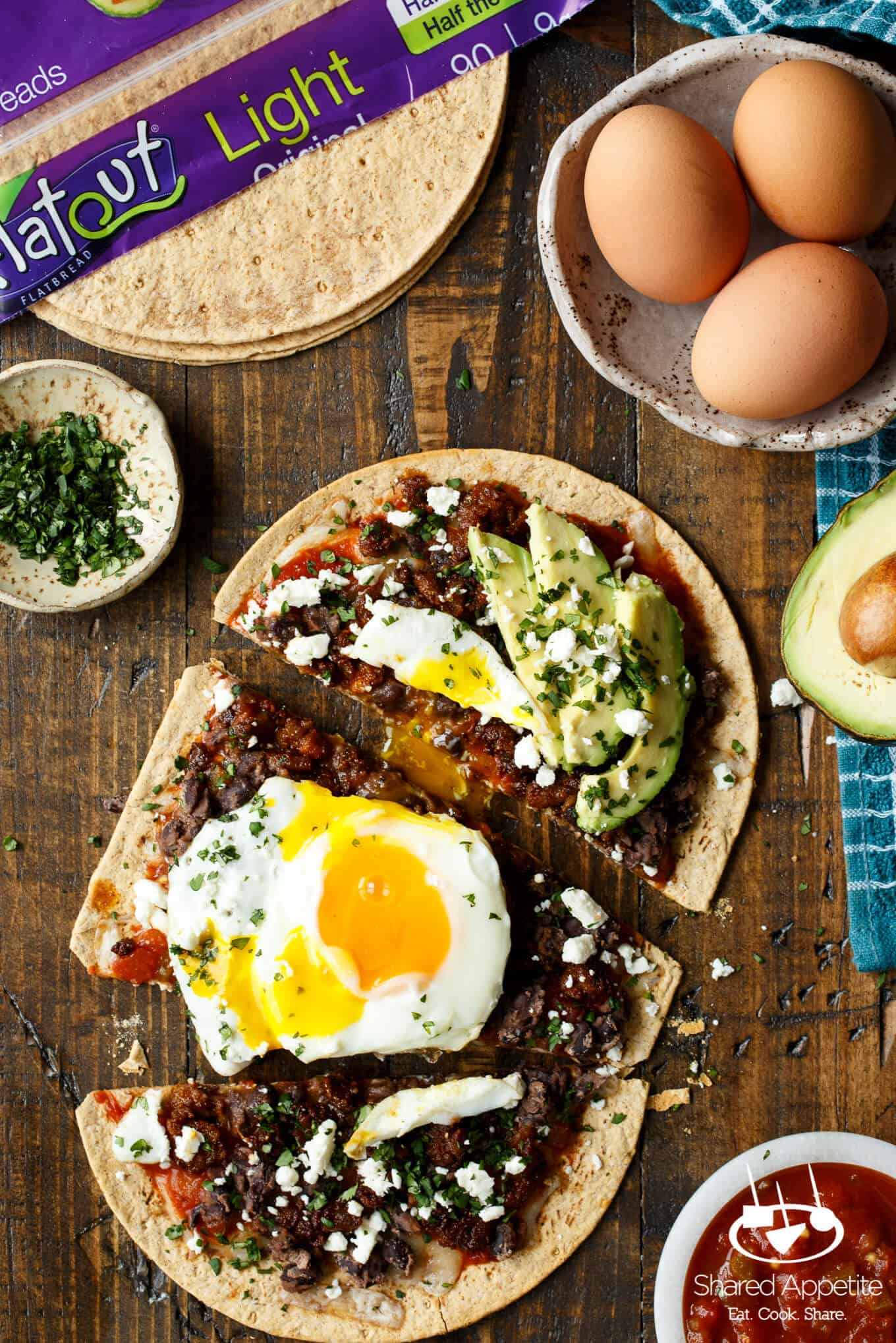 Huevos Rancheros Flatbread Pizza with Monterey Jack Cheese, Salsa, Black Beans, Avocado, and a Fried Egg! sharedappetite.com