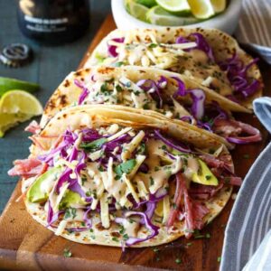 Slow Cooker Corned Beef Tacos Guinness Braised with Guinness Cream Sauce, Red Cabbage, and Avocado | sharedappetite.com