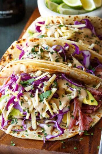 Slow Cooker Corned Beef Tacos Guinness Braised with Guinness Cream Sauce, Red Cabbage, and Avocado | sharedappetite.com