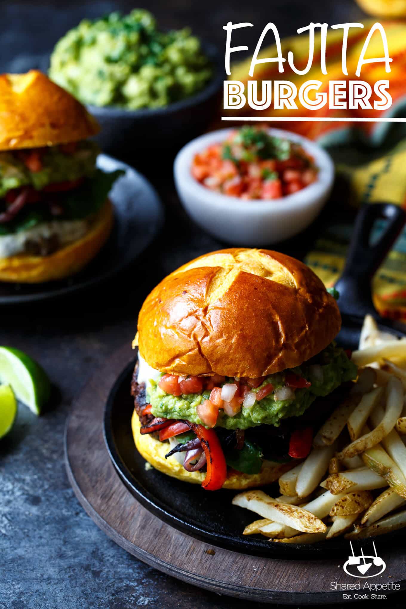 Fajita Burgers with grilled peppers and onions, guacamole, and pico de gallo | sharedappetite.com