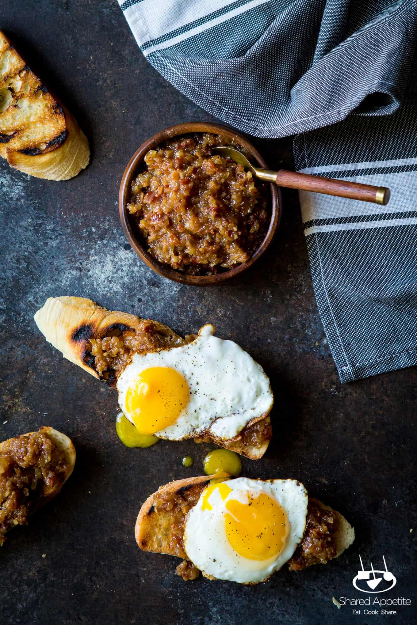 Bacon Jam made with onions, bacon, and apple juice! The perfect condiment for avocado toast, burgers, and goes great with eggs! Full recipe on sharedappetite.com