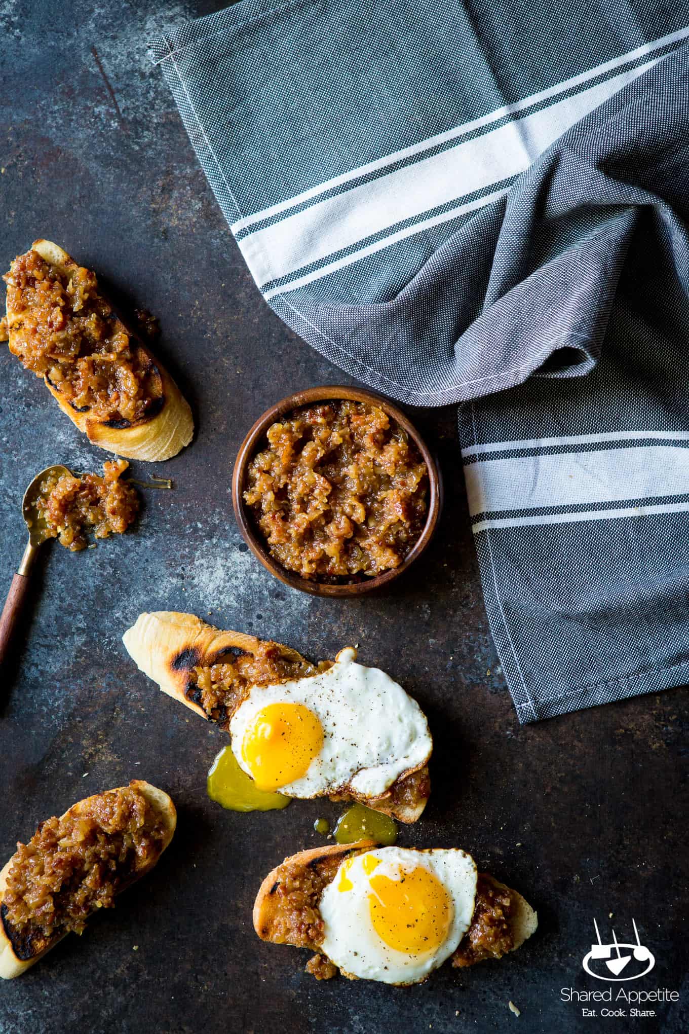 Bacon Jam made with onions, bacon, and apple juice! The perfect condiment for avocado toast, burgers, and goes great with eggs! Full recipe on sharedappetite.com