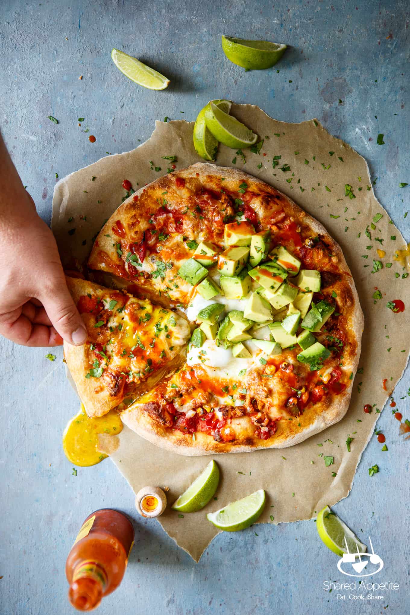 Picking up a slice of Huevos Rancheros Pizza with Turkey Chorizo | sharedappetite.com