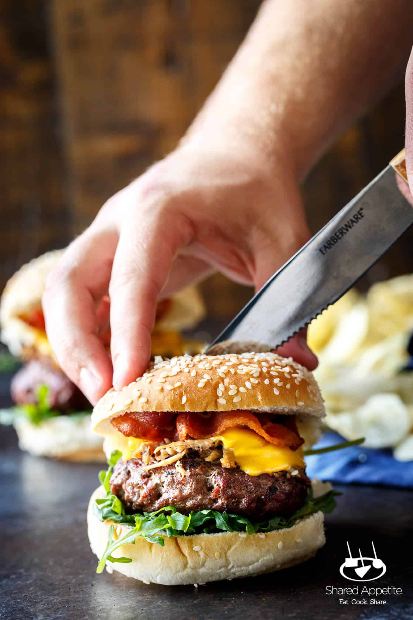 Cutting into the Pulled Pork Bacon Cheeseburgers | sharedappetite.com
