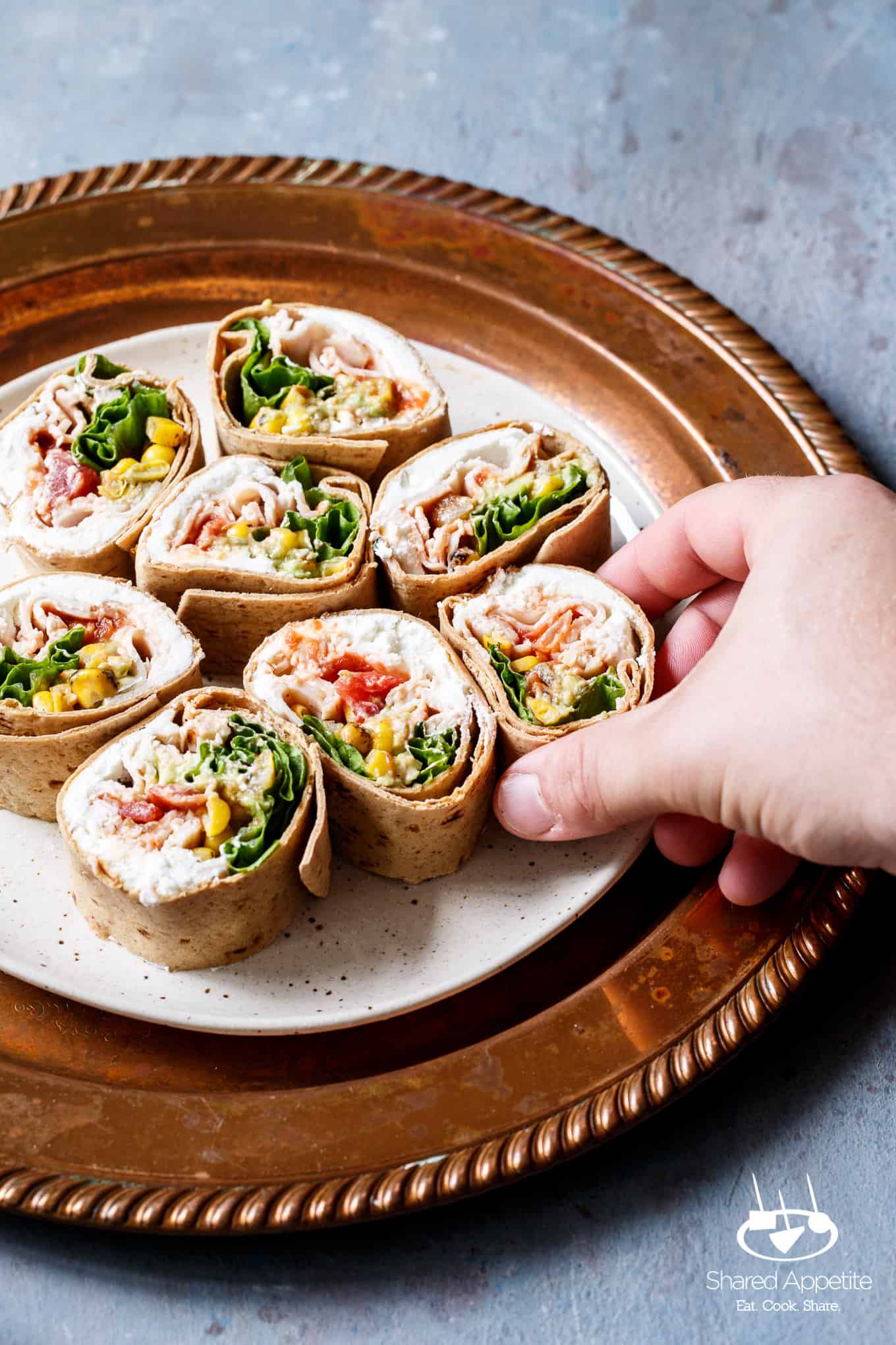 Grabbing a pinwheel of the Southwest Turkey Wraps | sharedappetite.com