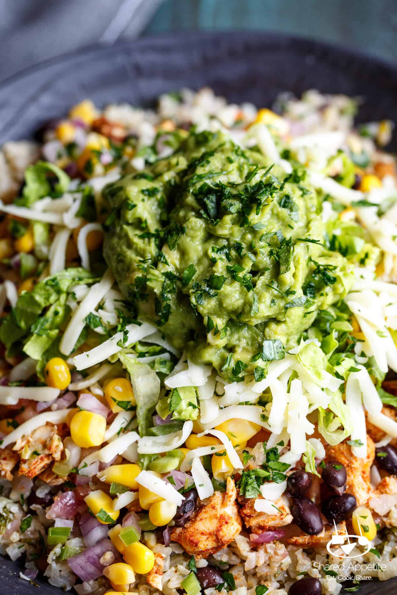 Zoomed in on the Guacamole on this Healthy Cauliflower Rice Burrito Bowls | sharedappetite.com