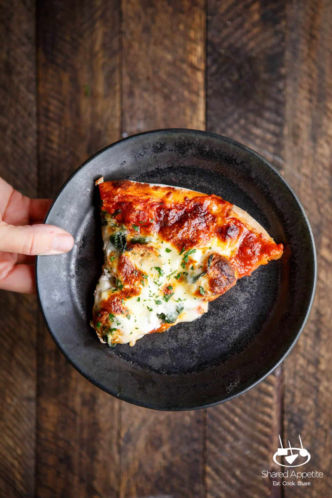 a slice of this Meatball, Spinach, and Ricotta Pizza on a plate
