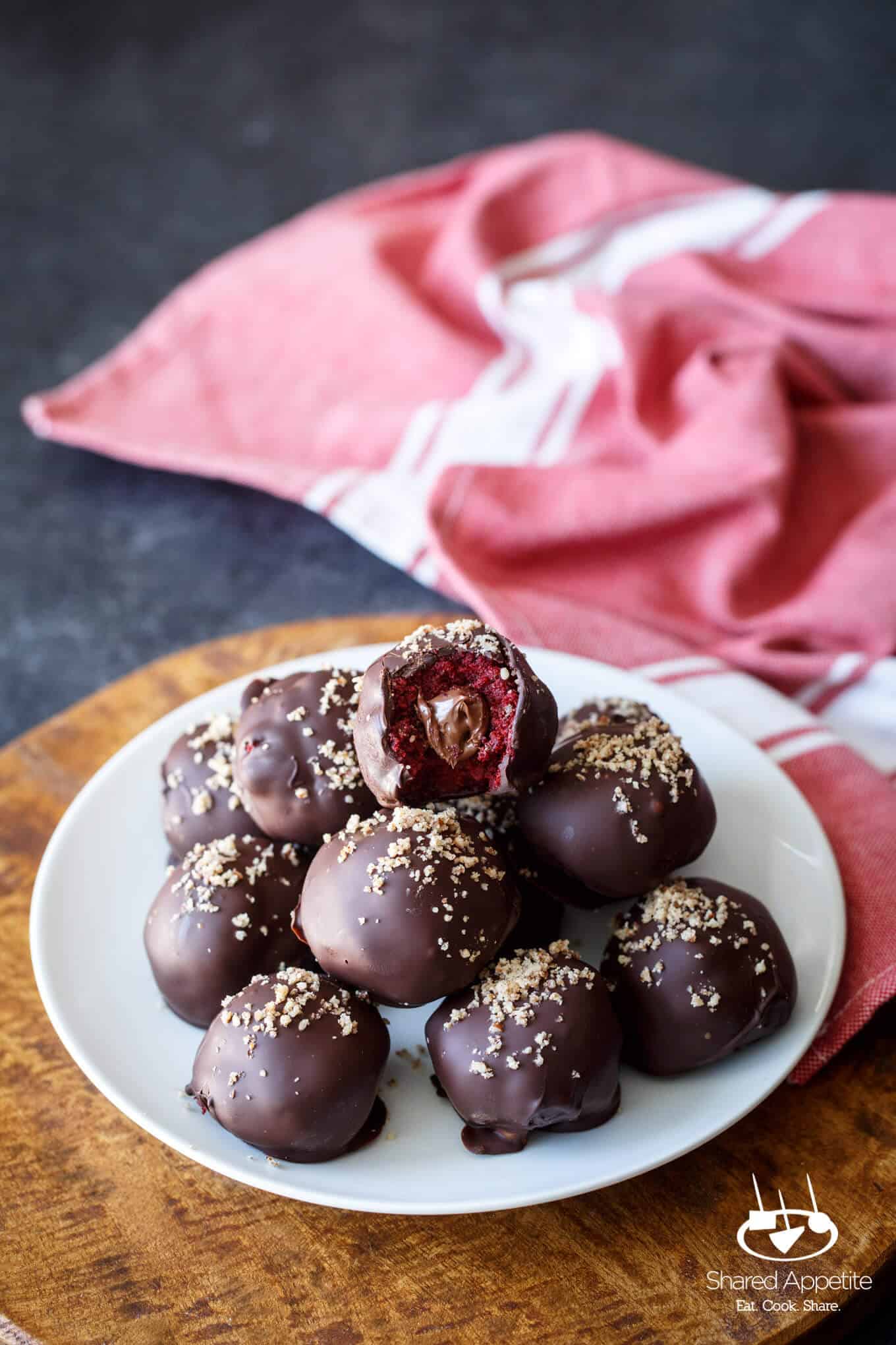 Nutella Filled Red Velvet Cake Truffles on a plate | sharedappetite.com