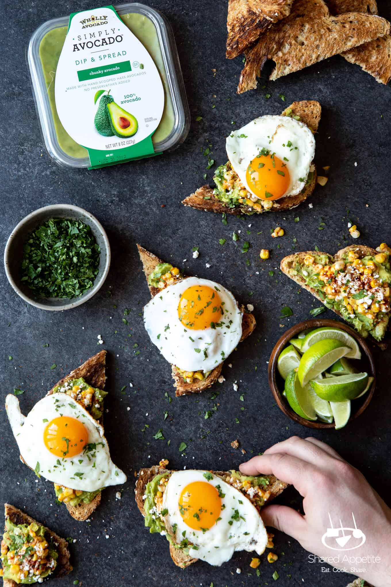 Grabbing an Elotes Avocado Toast with a Fried Egg | sharedappetite.com