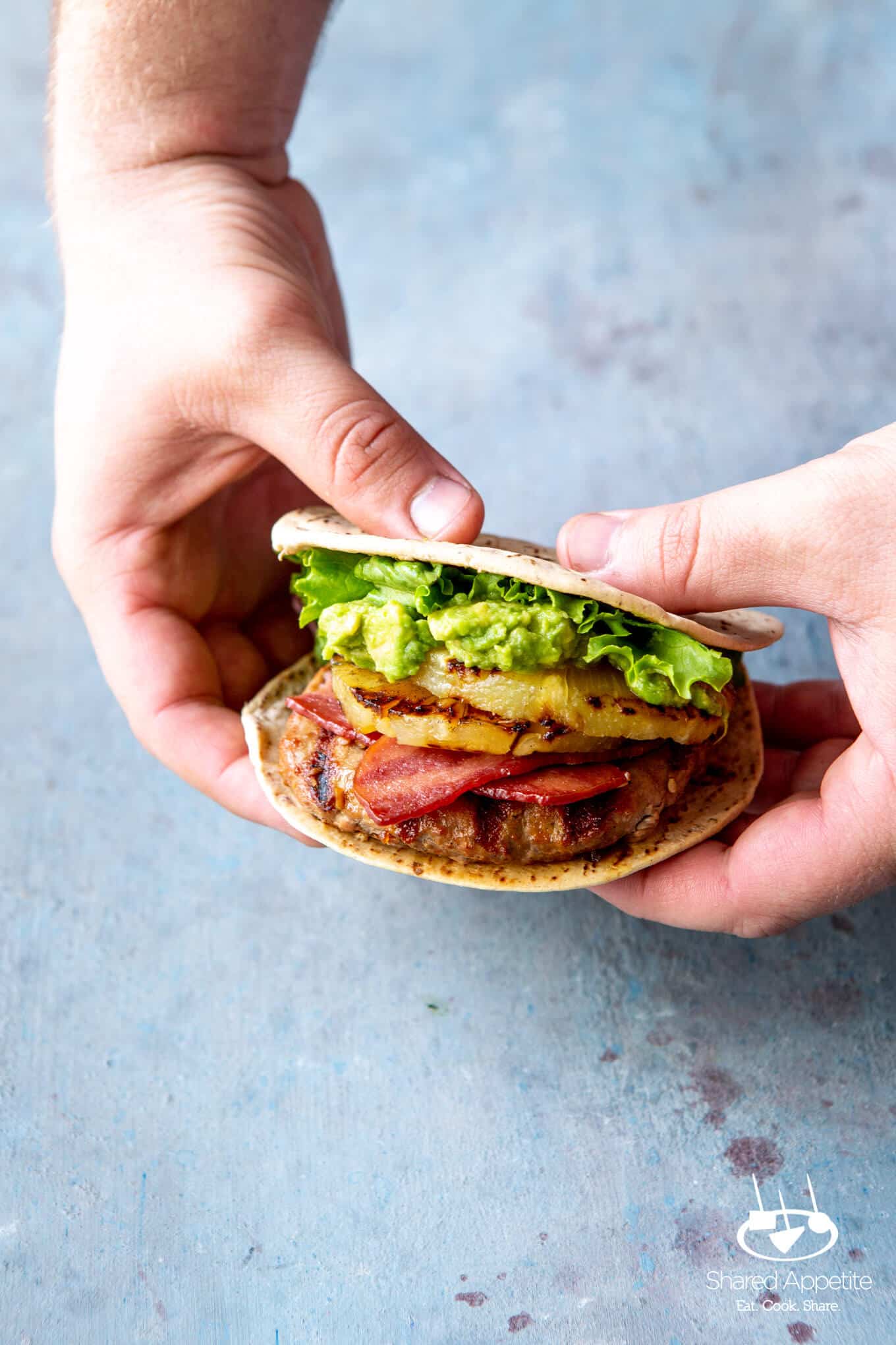 Hawaiian Turkey Burgers with Grilled Pineapple, Turkey Bacon, and Mashed Avocado | sharedappetite.com