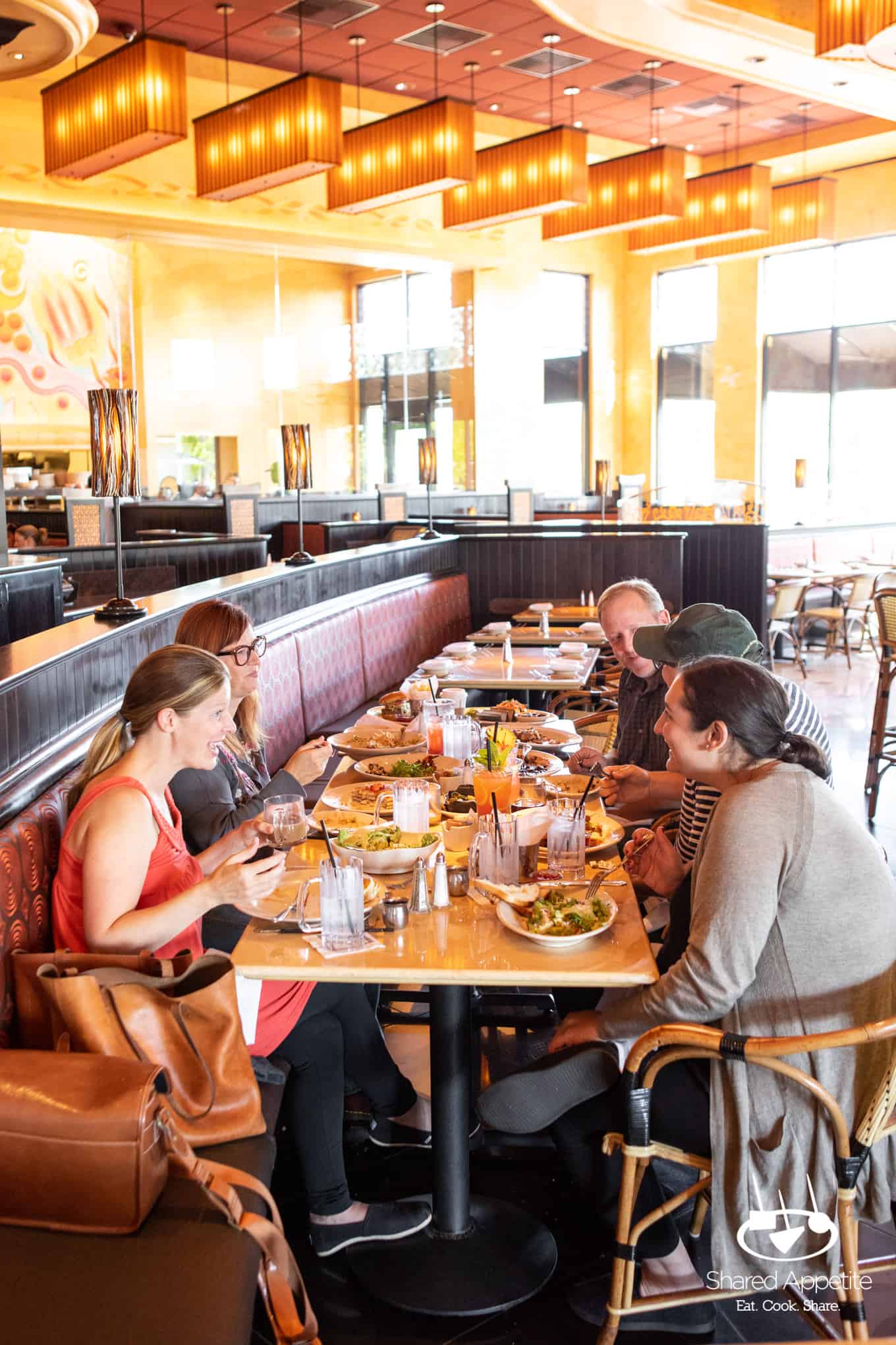 Friends enjoying meal at The Cheesecake Factory | sharedappetite.com